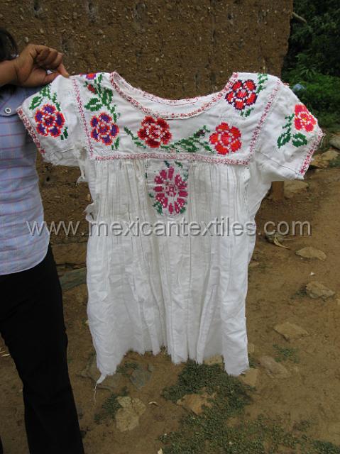 trapiche_viejo__31.JPG - Older worn blouse with hand embroidered trim , which is now deteriorated from use.